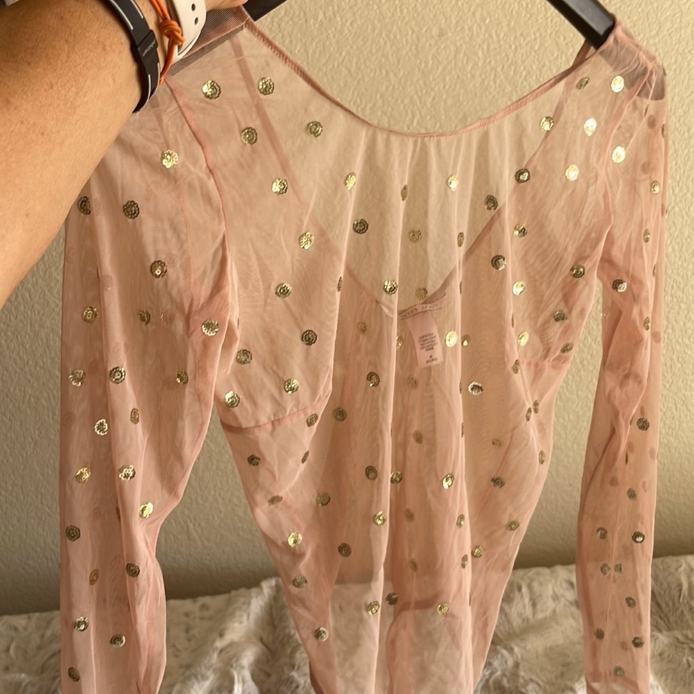 Sheer, nude bodysuit with gold sequins.